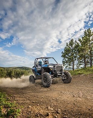 ATV blasting through gravel road