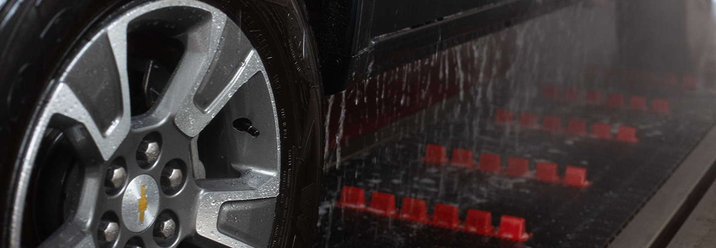Black pickup truck going through automatic car wash