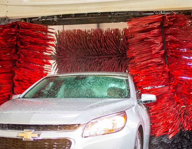 Silver car going through automatic car wash