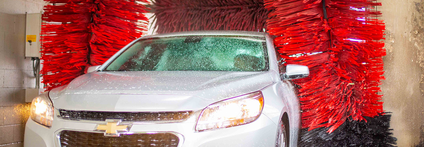 silver chevy going through automatic car wash