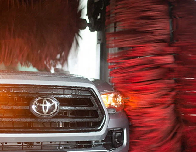 Toyota driving through automatic car wash