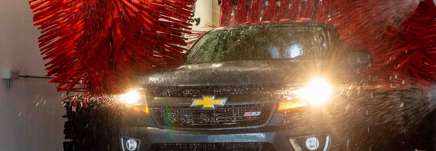 Chevy truck driving through automatic car wash
