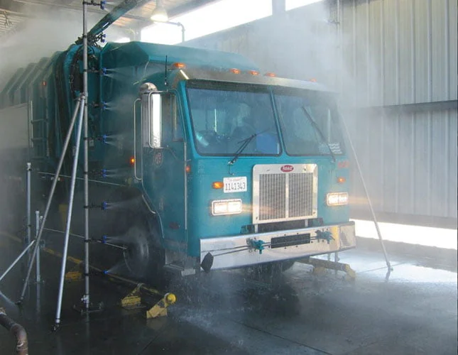 blue truck driving through a wash