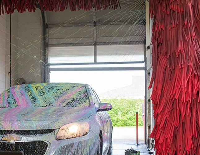 Chevy getting sprayed with soap in automatic car wash