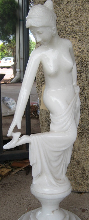 Marble lady touching foot.