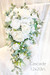 White cascading bridal bouquet with lily of the valley, roses & hydrangea designed by The Brides Bouquet.