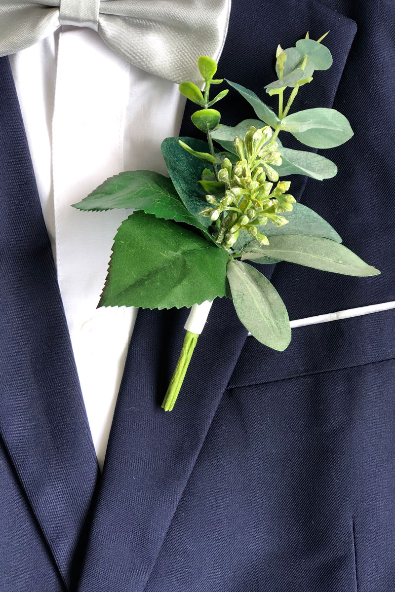 Close-up of a ring bearer's boutonniere and pocket square stock photo -  OFFSET