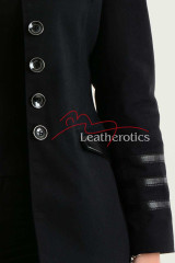 Close-up of silver button detailing on black military style blazer