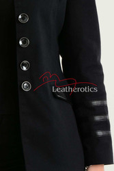 Close-up of silver button detailing on black military style blazer