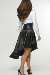 Side profile of women's premium leather skirt featuring elegant draped asymmetrical styling