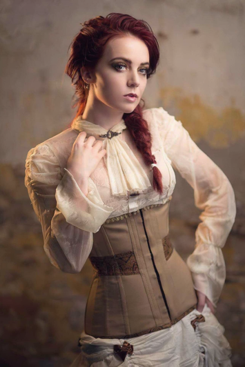 Close-up of brown brocade waist panel on beige cotton corset