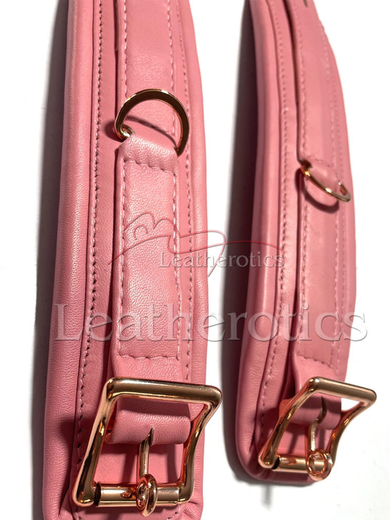 Real leather pink arm cuff showing sheepskin lining, secure locking buckle and restraint hardware for bondage play