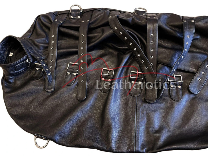 Detailed view showing the fully-lined interior and integrated arm restraint sleeves of the leather wrap-around body bag.