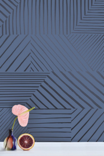 A collage of charcoal stripes, puzzled together in an asymmetrical pattern on navy wallpaper.