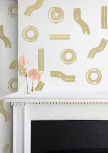 Artfully arranged gold circles and line on this cream wallpaper. 