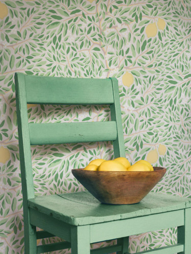 Chair with calming lemon wallpaper behaind it.