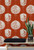 Burnt orange wallpaper with lucky lantern pattern.