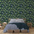 Bedroom featuring dark blue and green bird wallpaper.