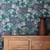 A floral medley, reminiscent of a summer flower meadow on teal wallpaper.