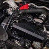 IAG black aluminum alternator cover with black hex accent plate on 2022-2026 Subaru WRX