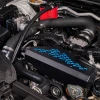 IAG black aluminum alternator cover with blue hex accent plate on 2022-2026 Subaru WRX