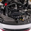 Top down view of IAG black aluminum alternator cover with stainless hex accent plate on 2022-2026 Subaru WRX