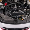 Top down view of IAG black aluminum alternator cover with white hex accent plate on 2022-2026 Subaru WRX