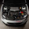 COBB Redline Gloss Carbon Fiber Fuse Cover Kit installed in 2022-2026 Subaru WRX engine bay