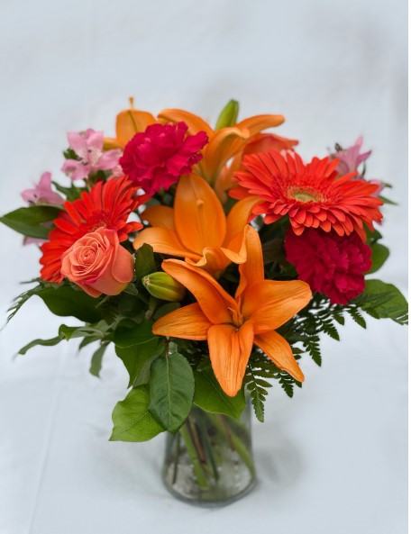 Express your caring thoughts with this graceful arrangement that includes one of the year’s most popular colors