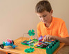 young boy playing with elenco snap circuits green energy kit on table