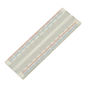 white rectangular board with many tiny holes and red and blue lines along the length of each side