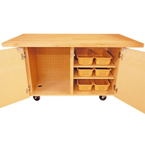 wooden work bench has 1-3/4" thick table top with two open cabinets to reveal six plastic organizational trays