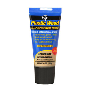 blue plastic tube of dap plastic wood all purpose wood filler in golden oak color with black screw cap blue plastic tube of dap plastic wood all purpose wood filler in golden oak color with black screw cap