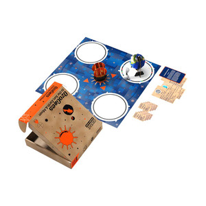 ozobot ozogoes to the sun, earth, and moon kit with completed projects on mat next to cards near box ozobot ozogoes to the sun, earth, and moon kit with completed projects on mat next to cards near box