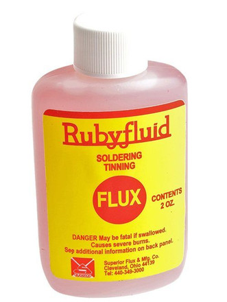 plastic bottle of thin pink soldering and tinning flux that has yellow label with red text and white cap