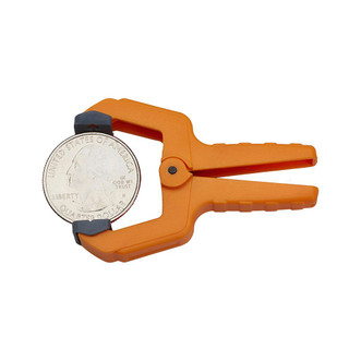 orange 1" capacity Bora Portamate Mini Spring Clamp with gray tips holding silver American quarter
