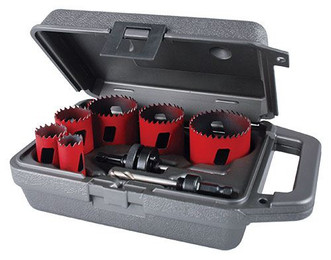 gray plastic toolbox holding 6 red hole saws in different sizes and 2 arbors