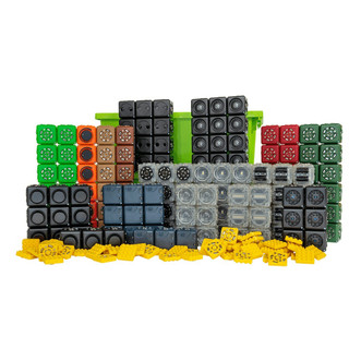 cubelets in black, green, red, tan, brown, and gray, arranged around green storage container with yellow brick adapters