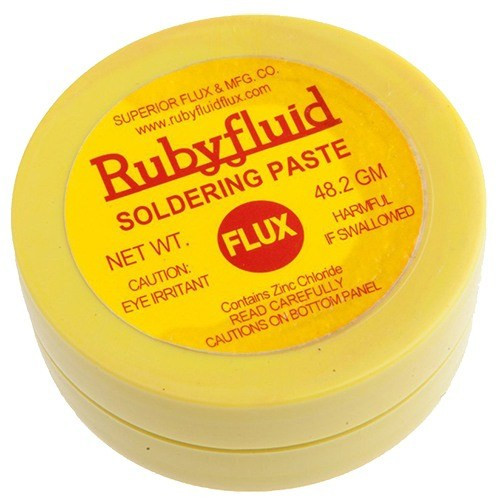 1.69 ounce yellow plastic jar of ruby fluid soldering paste with yellow label and red text
