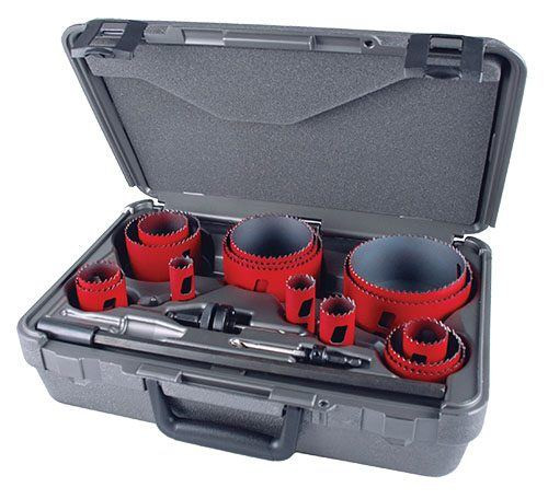 gray plastic toolbox holding 15 red hole saws in different sizes, 2 arbors and 1 extension
