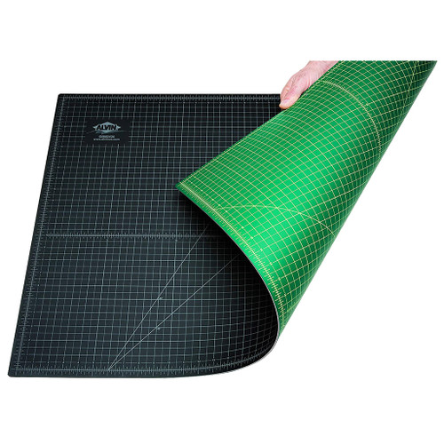 hand showing reversible sides of 24" x 36" alvin professional self-healing cutting mat with white lines