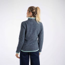 Rear view of a woman wearing a navy waffle-textured fleece with mint green trim at the hem, cuffs, and collar.