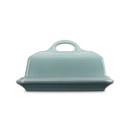 A blue Le Creuset butter dish from the side