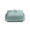 A blue butter dish with Le Creuset branding