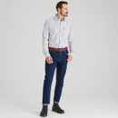 Men’s navy check country shirt paired with dark denim jeans and brown leather belt, model standing in a studio for a full-length outfit view.