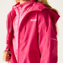 A person wearing a bright pink jacket with a hood and a high collar is visible. The jacket has white "Regatta Great Outdoors" branding and reflective details.