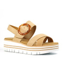 Tan platform sandals with a chunky white sole, featuring a decorative circular buckle and a comfortable, open design. Tan platform sandals with a chunky white sole, featuring a decorative circular buckle and a comfortable, open design.
