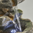 A close up of the water cascading into the pool below with LED's