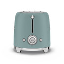 A retro-style emerald green toaster with chrome accents, featuring a central control dial and various function buttons for toasting.