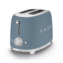 Smeg toaster in storm blue with chrome accents, featuring two slots, a dial, and a "STOP" button for toasting control.